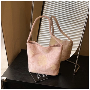 Detail of pink floral canvas bucket bag with vintage peony patterns in a room setup