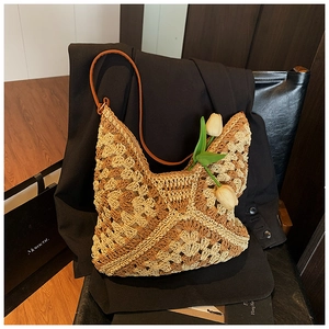 Detail of checkered straw hobo bag with leather strap and decorative tulips
