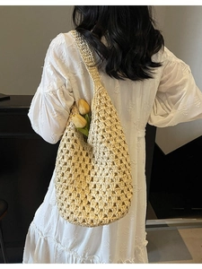 Handmade beige hollow woven straw shoulder bag with minimalist large mesh for beach travel