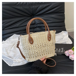 Detail of straw woven tote with premium brown leather straps and canvas drawstring lining