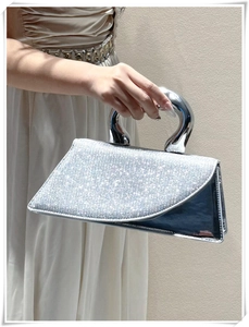 Silver rhinestone handbag featuring a sleek polished U-shaped metal handle and flap cover