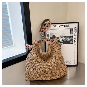 Detail showing the intricate hollow-out weaving pattern of the large straw tote bag