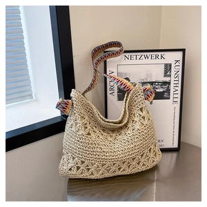 Detailed texture of hollow mesh crochet tote bag with colorful geometric woven shoulder strap