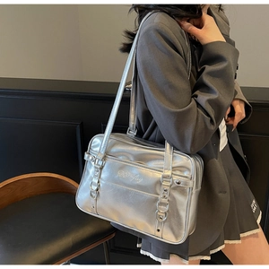 Silver metallic PU shoulder bag detail showing De Luy embroidery and zipper pocket