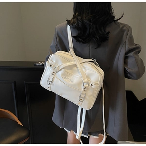 Rear view of model wearing white PU leather tote bag with silver metal ring accents