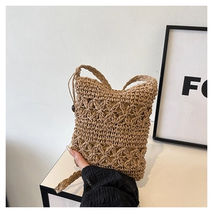 Close-up of handwoven straw bucket bag with hollow patterns and woven strap for summer