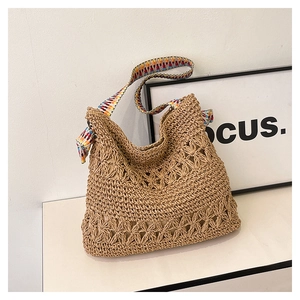 Detailed macro of woven straw tote bag featuring intricate floral hollow base design