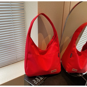 Detail of red canvas hobo bag showing spacious interior and comfort wide shoulder strap
