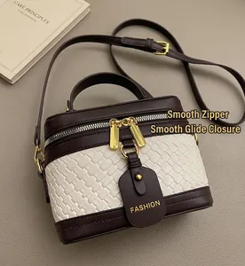 Detail of vintage patchwork handbag with brown leather and beige weave on a blazer