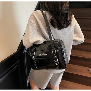Close-up of black glossy PU leather shoulder bag featuring silver Do fuy logo and straps