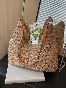 Hollow crochet straw tote bag with brown leather straps for beach vacation styling