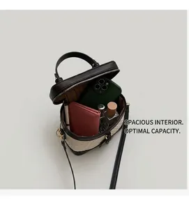 Detail view of woven bucket bag interior showing phone, wallet, and lipstick storage