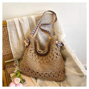 Detail of hand-woven straw tote with ethnic style colorful strap on a vintage chair