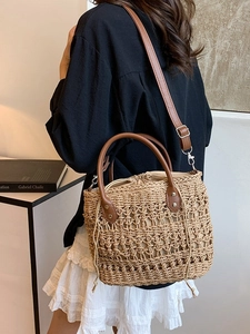 Large capacity straw bucket bag with brown leather straps and drawstring interior