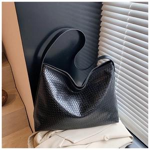 Detailed view of the black woven texture and leather-like finish on the large hobo bag