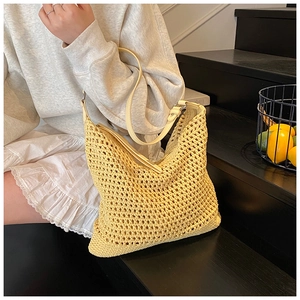 Detail of yellow crochet shoulder bag with cream leather strap and mesh knit texture