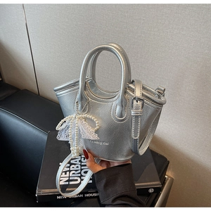 Silver mini handbag featuring metallic embossed texture and pearl lace bow charm detail