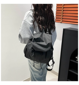 Detailed back view of casual black drawstring nylon backpack for daily commuting