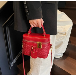 Close-up of red PU leather bucket bag featuring woven texture and fashion tag detail