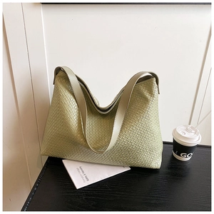 Detail shot of green woven hobo bag showing high-gloss leather texture and tight weave