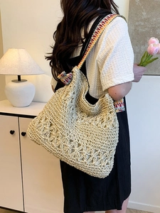 Bohemian woven straw tote bag with floral patterns and colorful striped shoulder straps