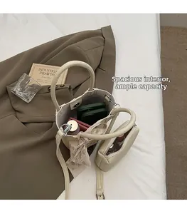 Detailed view of beige bucket bag with large capacity storage for essentials