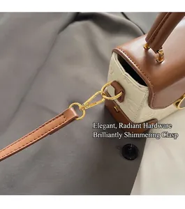 Detail view of the vintage contrast color handbag featuring premium gold-tone hardware