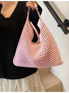 Pink hand-woven crochet hobo shoulder bag with leather straps for beach vacations