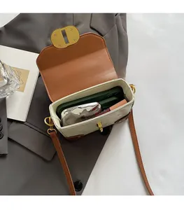 Internal view showing storage capacity of a vintage cream leather crossbody square bag