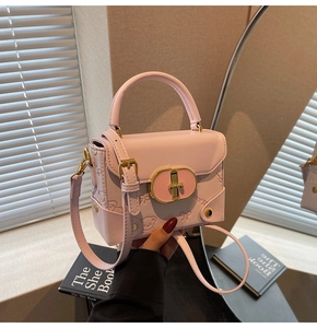Detail of pink faux leather bag showing 3D embossed teddy bear patterns and metal lock