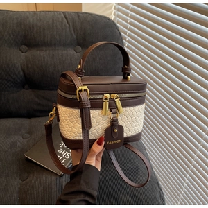 Detail view of the vintage box bag showing two-tone leather trim and woven texture