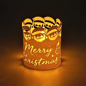 Detail of warm LED Christmas lantern with Merry Christmas carving and Santa patterns
