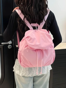 Pink lightweight nylon backpack with drawstring closure shown on a model back
