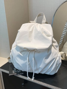 Minimalist white quilted backpack with drawstring detail for women casual daily use