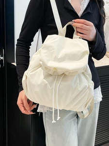 Minimalist cream white quilted backpack for women with drawstring closure and fold-over flap