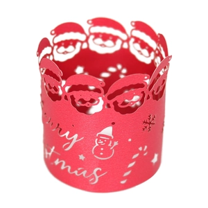 Detail of red laser-cut Christmas napkin ring with Santa Claus and snowflake motifs