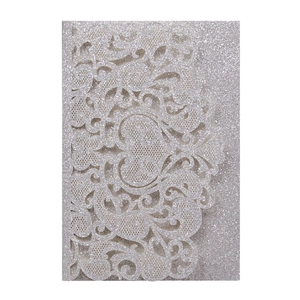 Detailed laser cut silver glitter wedding invitation with intricate floral lace patterns