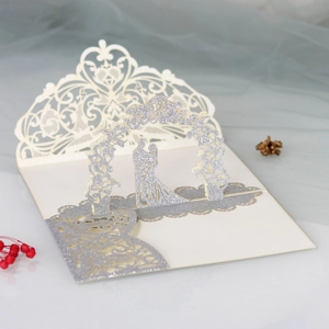 Detailed 3D pop-up wedding card with glittery bride, groom and laser-cut floral arch