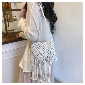 Detail of bohemian handmade cotton woven shoulder bag with stylish fringe and mesh pattern