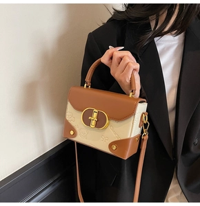Detail showing contrast flap bag with golden twist lock and teddy bear embossing