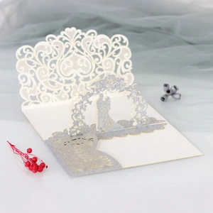 Detailed laser-cut 3D wedding card with silver glitter couple silhouette and lace pattern