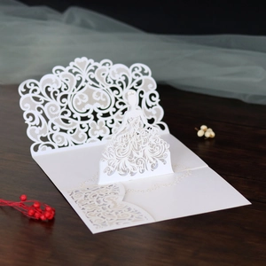 Close-up of laser-cut 3D bride figure and intricate lace patterns on white card