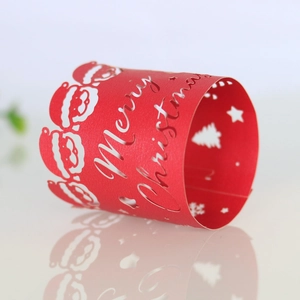 Detail view of red laser-cut Christmas napkin ring with Merry Christmas lettering