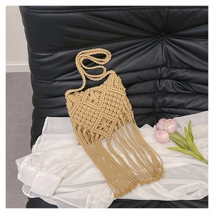 Detailed view of bohemian hand-woven cotton rope crossbody bag with long tassels