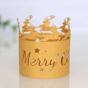 Close-up of golden reindeer glitter paper candle wrap with Merry Christmas cutout design