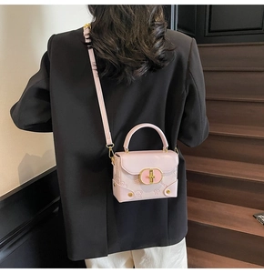 Pink mini crossbody bag featuring cute cartoon bear embossing and gold oval buckle