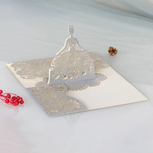 Detailed laser-cut pop-up card featuring a glittery princess dress and floral lace patterns