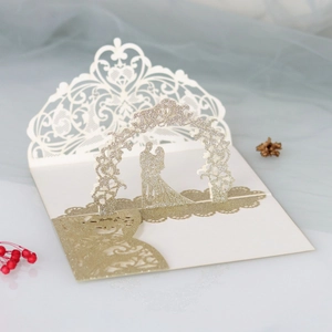 Macro detail of 3D rose wedding invitation with gold glitter and laser cut design