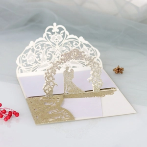 Detail of laser cut 3D rose wedding invitation with gold glitter couple silhouette