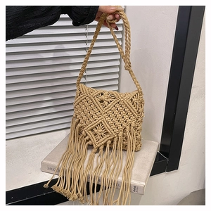 Detail view of Bohemian handmade cotton rope woven crossbody bag with long tassel accents